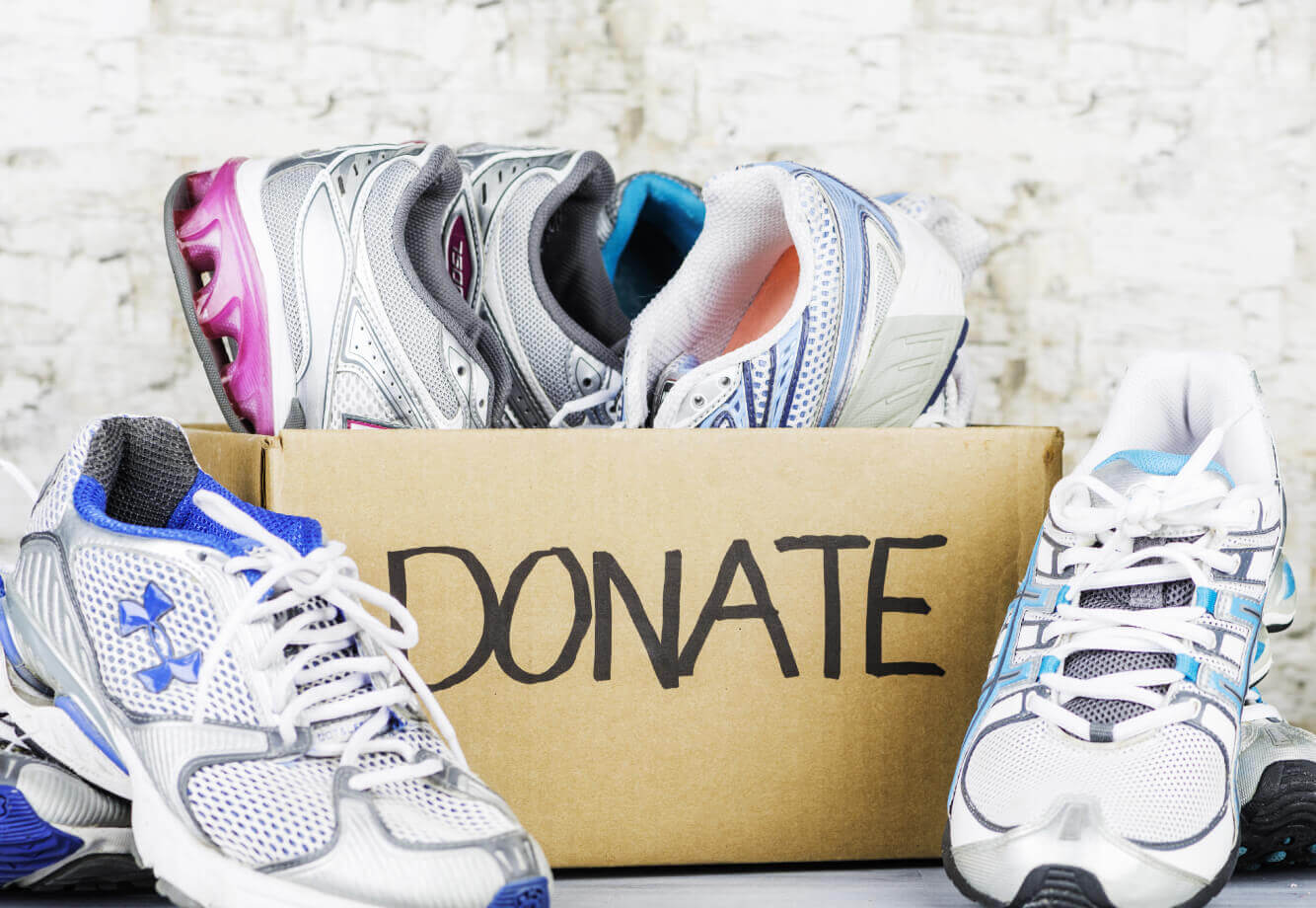 Village Clubs at DC Ranch donation box filled with athletic shoes and sneakers, supporting local community programs.